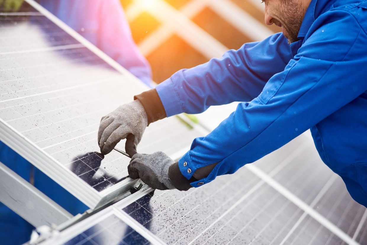 Technician Working on Solar Panels Shutterstock